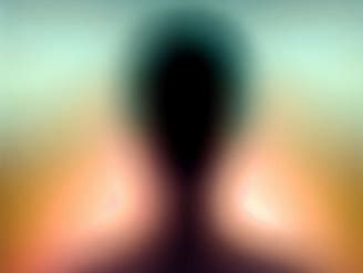 Person's sillouette surrounded by layers of color, or Aura.