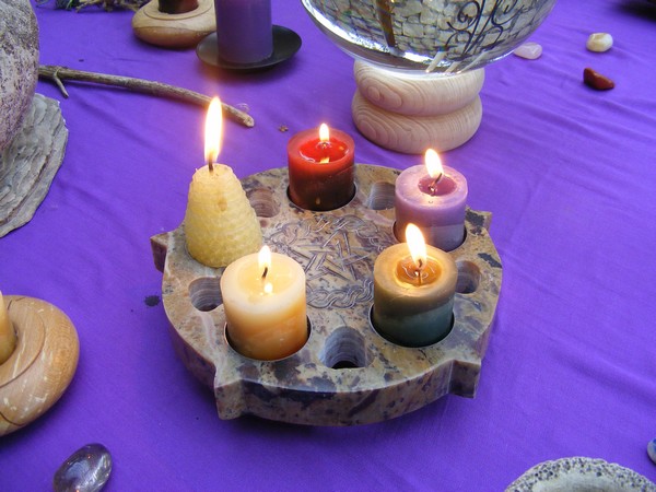 An array of different lit candles