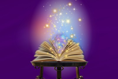 An open book emitting sparkles like magic.