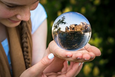 Young woman staring at a crystal ball.