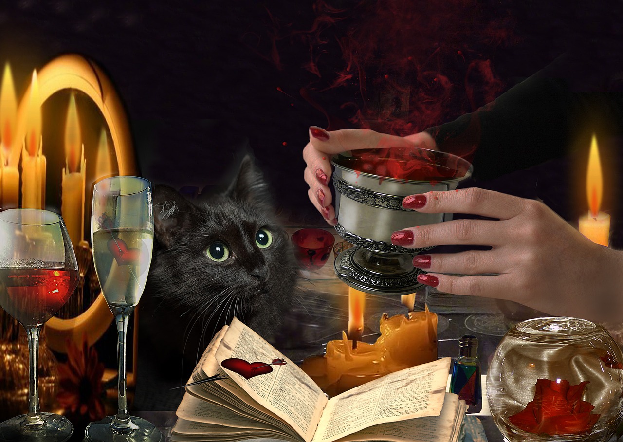 A black cat with green eyes stares at a person holding a chalice over a candle, surrounded by mysterious objects and a dark background.