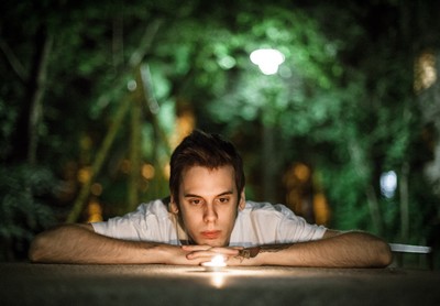 A man concentrating and looking at a candle