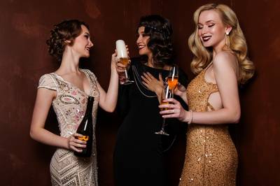 Three young women drinking champagne
