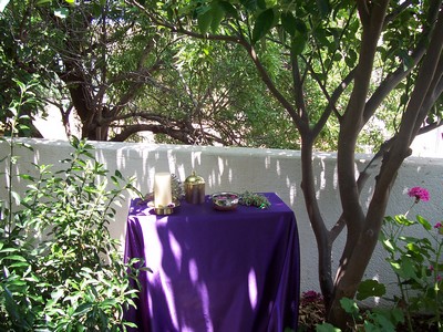 a purple cloth draped table outside as an Altar