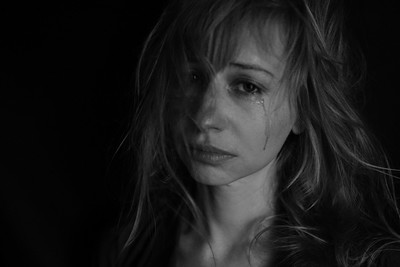 A woman looking very sad and quietly tearful
