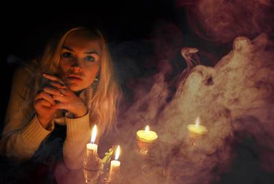 Woman surrounded by mystical candle flames