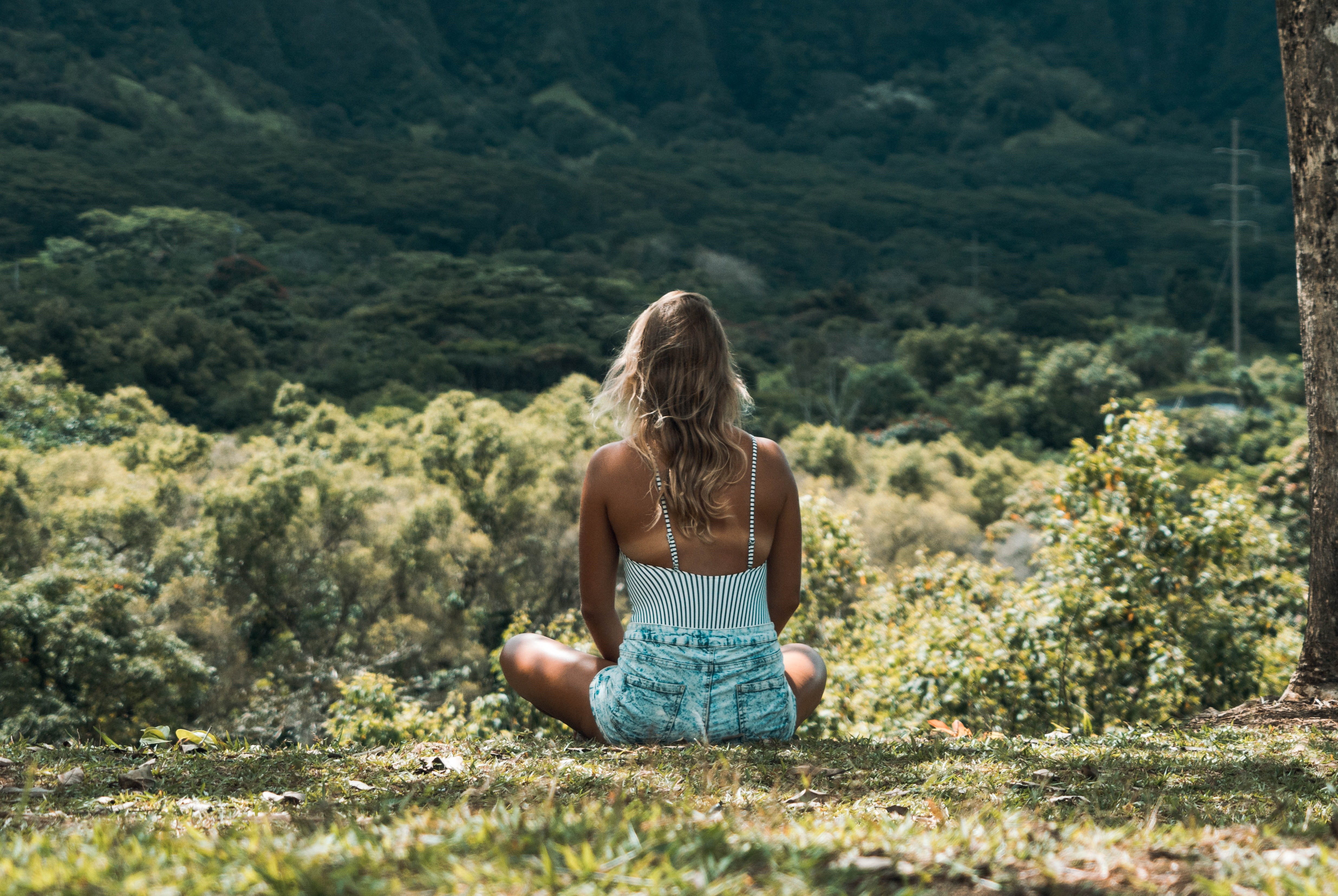 Girl sat down in a field meditating
