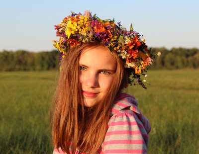Young girl with spring flower garland on her head Young girl with spring flower garland on her head