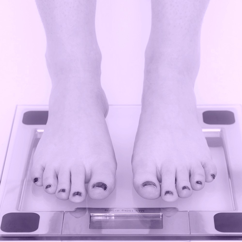 Bare feet on weighing scales