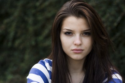 Portrait of a young woman with long dark hair, wearing a blue and white striped top, set against a blurred green outdoor background. Clara freed from Curses with a Curse REmoval Spell. Portrait of a young woman with long dark hair, wearing a blue and white striped top, set against a blurred green outdoor background. Clara freed from Curses with a Curse REmoval Spell.