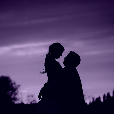 Loving couple in silhouette holding each other