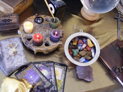 Altar adorned with crystals, candles and Tarot cards.