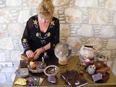 A woman at her Altar casting a spell.