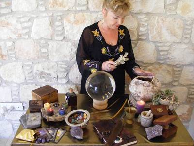 Woman Spell Caster at her Altar full of the trappings of Spell Casting.