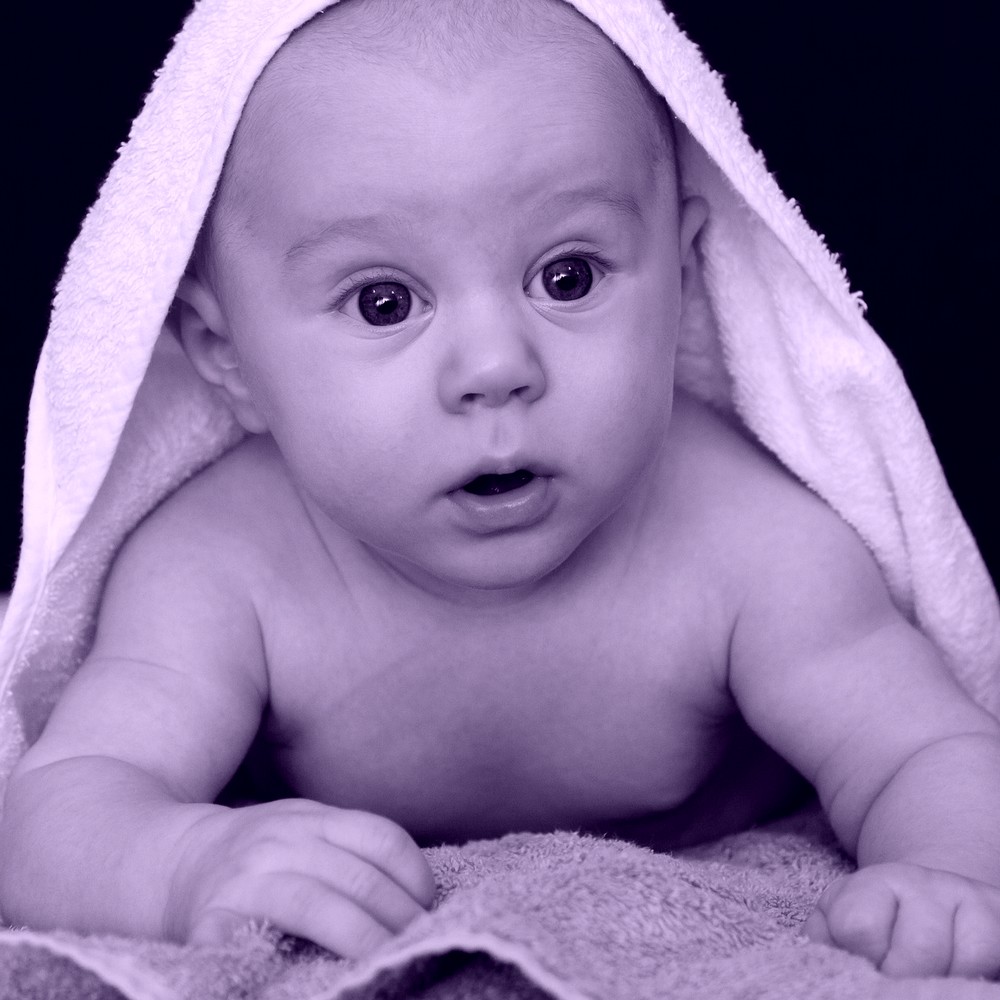 Cute baby with towel on head