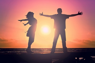 Man and woman celebrating the sunset.