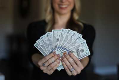 Woman fanning dollar bills