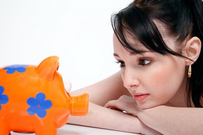 Woman staring at piggy bank