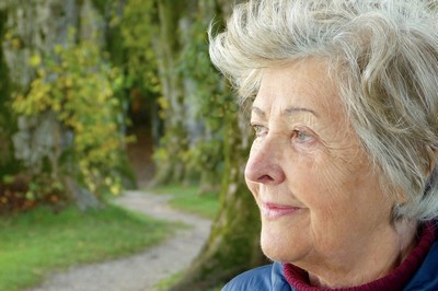 A woman looking serene and protected in the outdoors