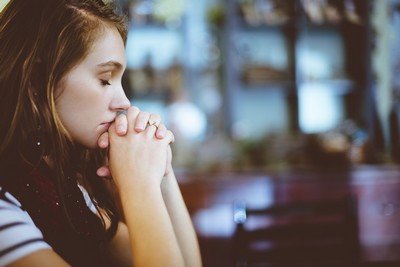 Woman eyes closed thinking