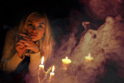 Girl staring next to candles