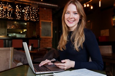 Smiling woman sat at her laptop.